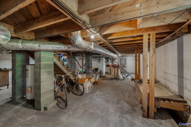 unfinished below grade area featuring water heater