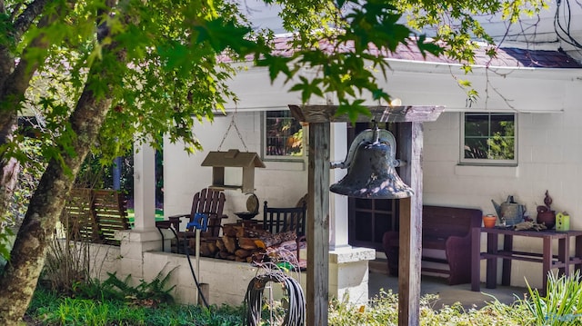 view of side of property featuring concrete block siding and a patio area