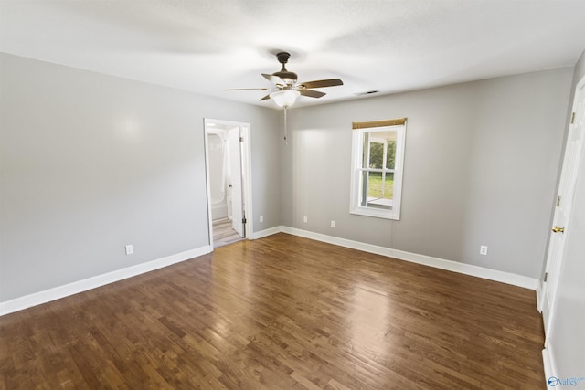 15766 Alabama Highway 79, Scottsboro, AL 35768 - spare room featuring dark wood-type flooring, a ceiling fan, and baseboards