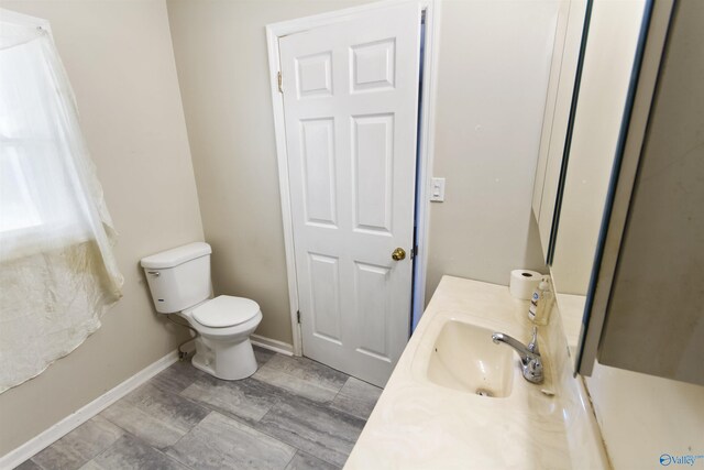 15766 Alabama Highway 79, Scottsboro, AL 35768 - half bathroom featuring toilet, baseboards, and vanity