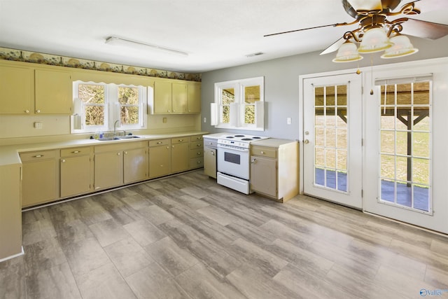15766 Alabama Highway 79, Scottsboro, AL 35768 - kitchen with white range with electric stovetop, a sink, light countertops, and a ceiling fan