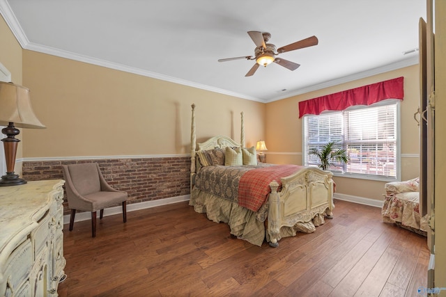 bedroom featuring ceiling fan, brick wall, wood finished floors, baseboards, and crown molding