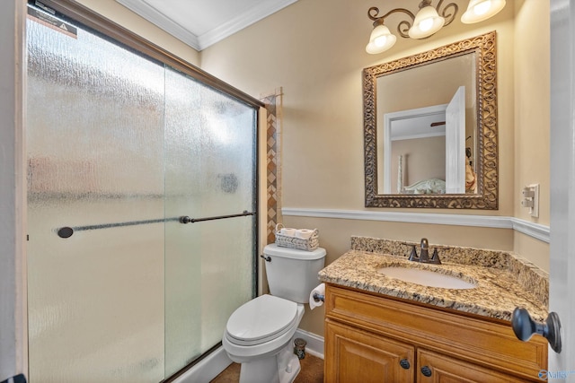 bathroom featuring ornamental molding, vanity, toilet, and a shower with shower door