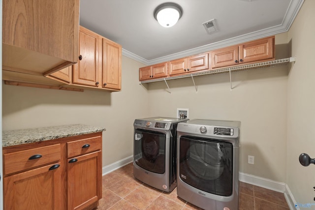 clothes washing area featuring visible vents, cabinet space, ornamental molding, washing machine and dryer, and baseboards