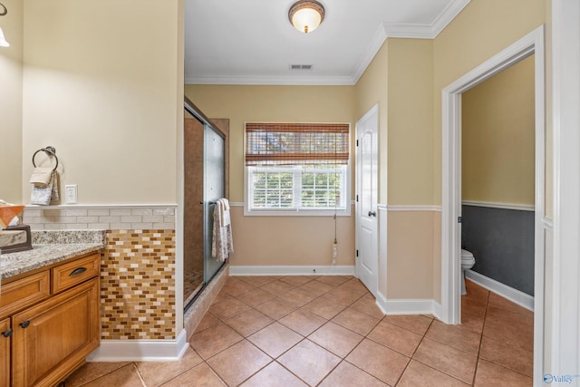 bathroom with toilet, walk in shower, tile patterned floors, crown molding, and vanity