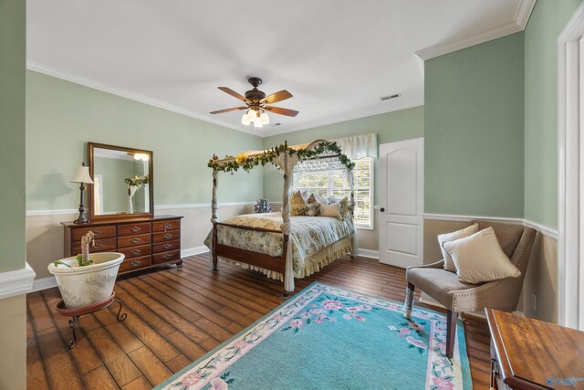 bedroom with dark wood-type flooring, ceiling fan, and ornamental molding