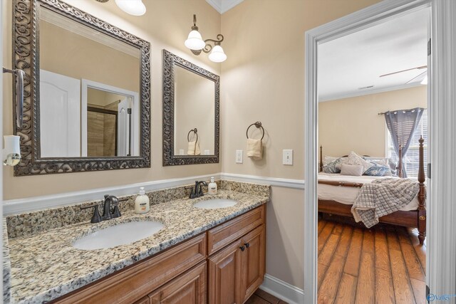 bathroom featuring crown molding, vanity, and hardwood / wood-style flooring