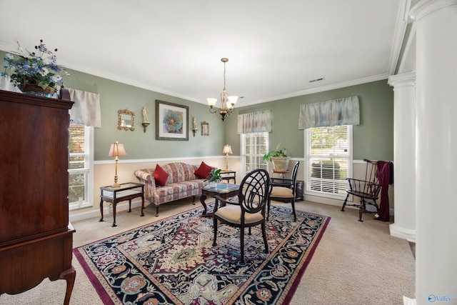 living room featuring ornamental molding, an inviting chandelier, light carpet, and decorative columns