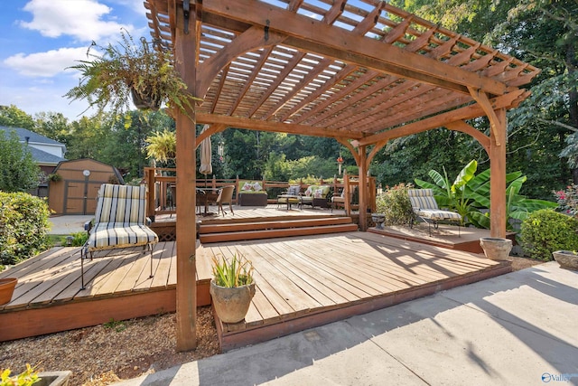 wooden terrace featuring a pergola and a shed