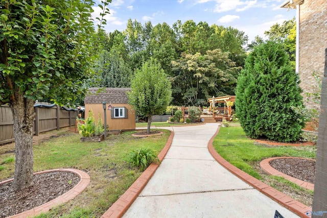 view of property's community featuring a lawn and a storage shed