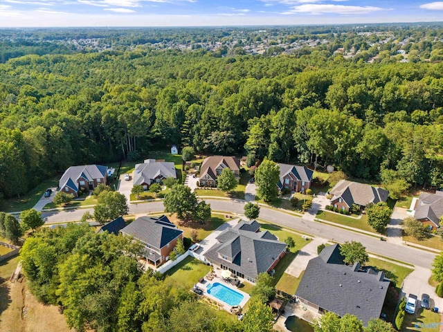 drone / aerial view with a residential view and a wooded view