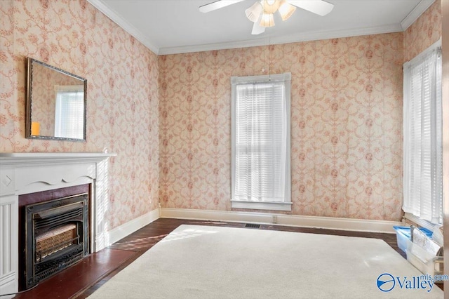 unfurnished living room with ceiling fan, a wealth of natural light, ornamental molding, and dark wood-type flooring