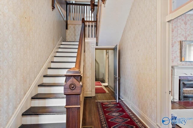 stairs featuring hardwood / wood-style floors