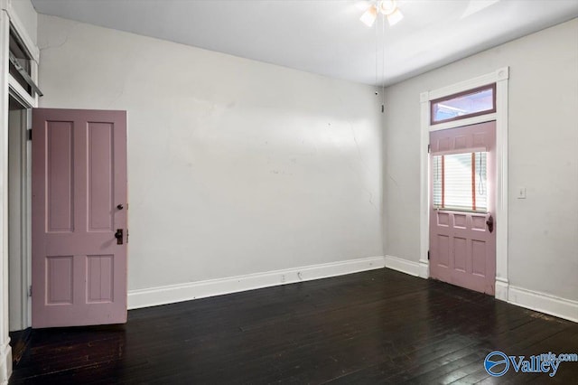 unfurnished room with dark hardwood / wood-style flooring