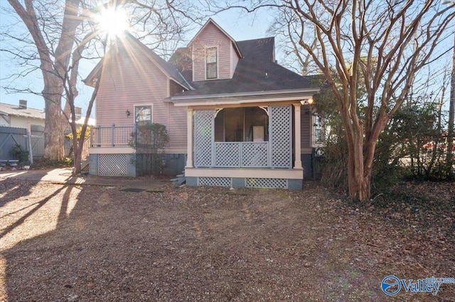 rear view of property featuring a porch