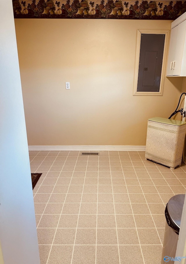 interior space with electric panel and light tile patterned floors