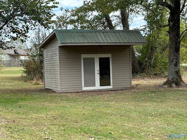 view of outbuilding featuring a lawn