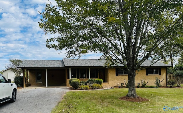 single story home with a front yard and a carport