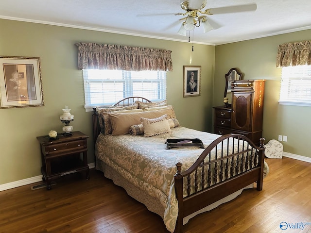 bedroom with multiple windows, ceiling fan, hardwood / wood-style floors, and crown molding