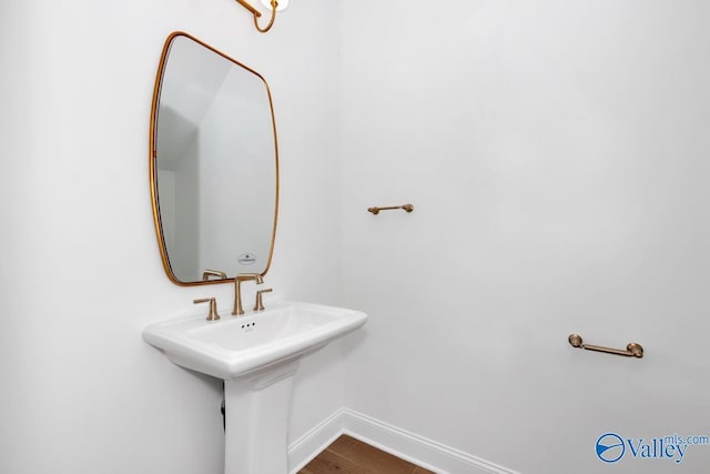 bathroom with wood-type flooring and sink