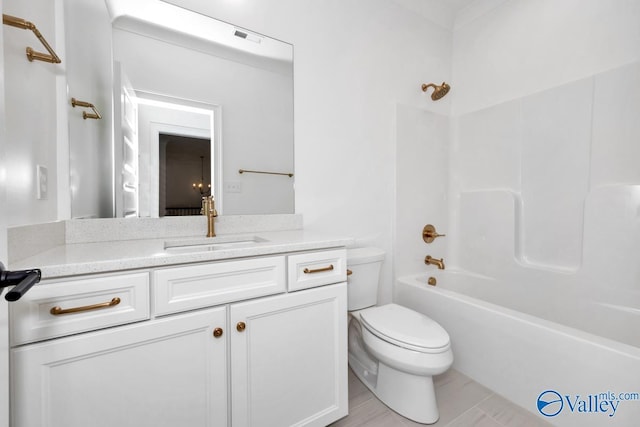 full bathroom with vanity, tub / shower combination, and toilet