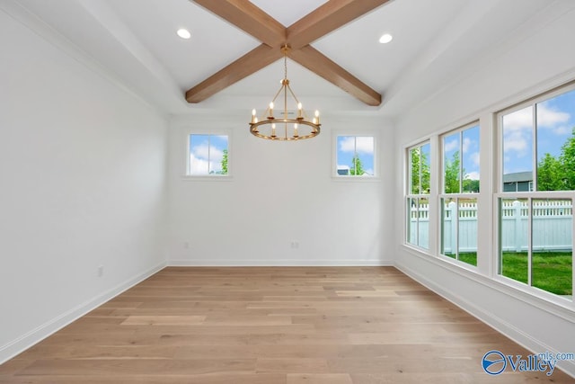 spare room with coffered ceiling, beam ceiling, light hardwood / wood-style flooring, and an inviting chandelier