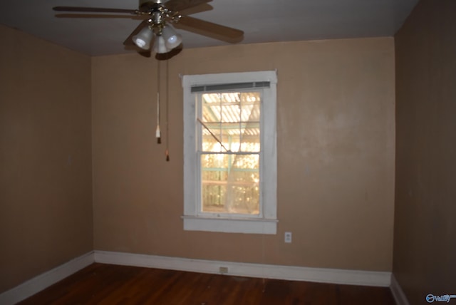 empty room with ceiling fan and dark wood-type flooring