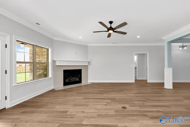 unfurnished living room featuring light hardwood / wood-style floors, ceiling fan, and crown molding