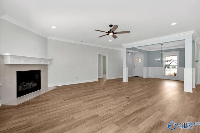 unfurnished living room featuring ornamental molding, ceiling fan with notable chandelier, and light hardwood / wood-style flooring