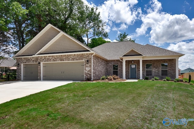 craftsman-style house featuring a garage and a front yard