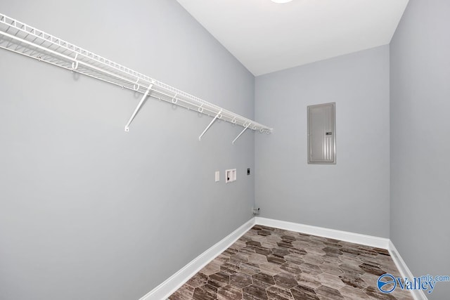 clothes washing area featuring electric panel, wood-type flooring, hookup for a washing machine, and hookup for an electric dryer