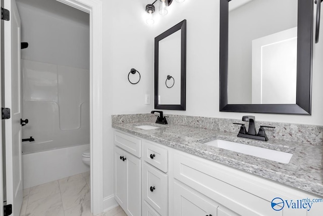 full bathroom with vanity, shower / tub combination, and toilet