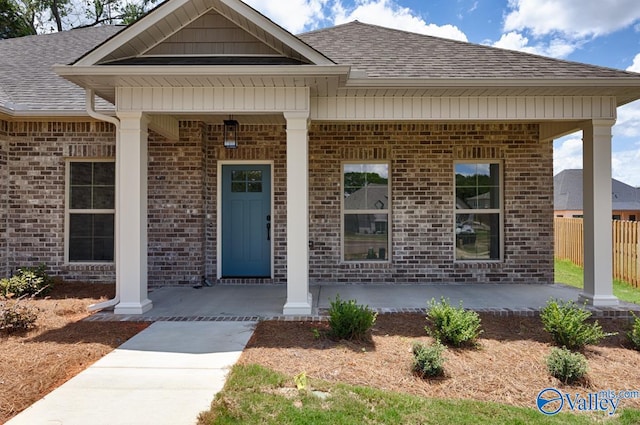 view of exterior entry with covered porch