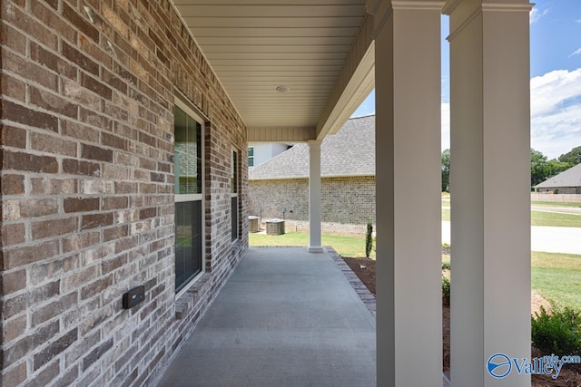 view of patio / terrace with a porch and cooling unit