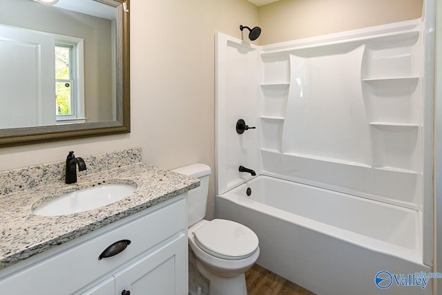 full bathroom featuring hardwood / wood-style floors, vanity, toilet, and shower / tub combination