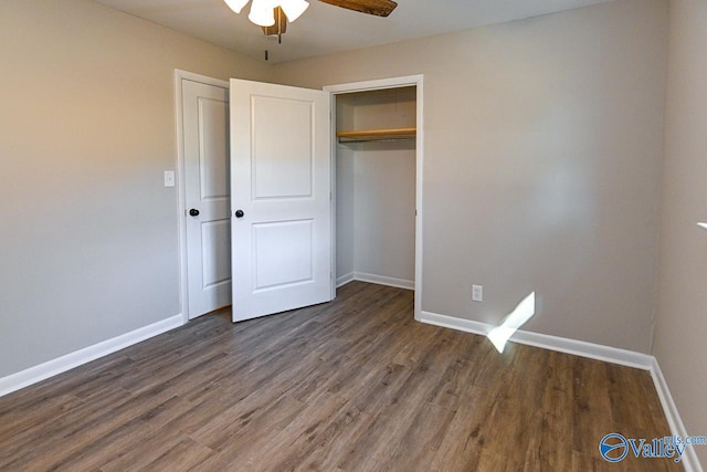 unfurnished bedroom featuring ceiling fan, dark hardwood / wood-style flooring, and a closet