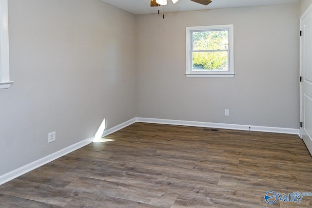 spare room featuring dark hardwood / wood-style flooring and ceiling fan