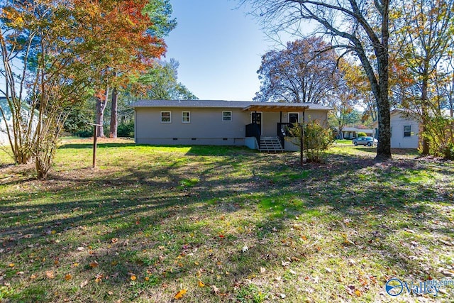 back of property featuring a yard