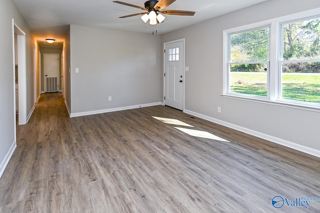 empty room featuring ceiling fan and dark hardwood / wood-style floors