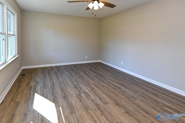 empty room with dark hardwood / wood-style floors and ceiling fan