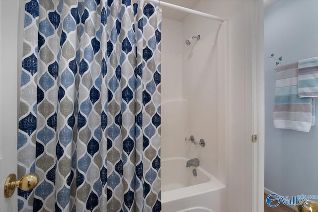 bathroom featuring shower / tub combo with curtain