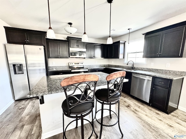 kitchen featuring pendant lighting, appliances with stainless steel finishes, and a center island