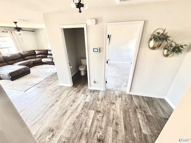 living room with light hardwood / wood-style flooring and ceiling fan