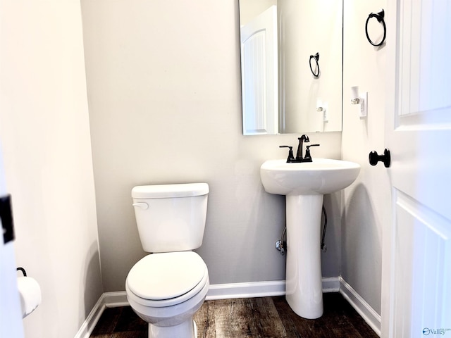 bathroom with wood-type flooring and toilet