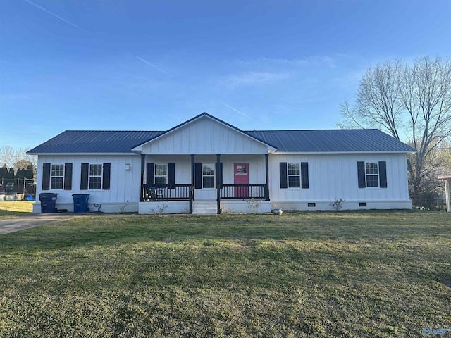 view of front facade with a front lawn, crawl space, metal roof, and covered porch