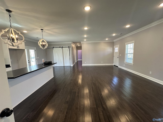 unfurnished living room featuring a wealth of natural light, a notable chandelier, baseboards, and dark wood finished floors