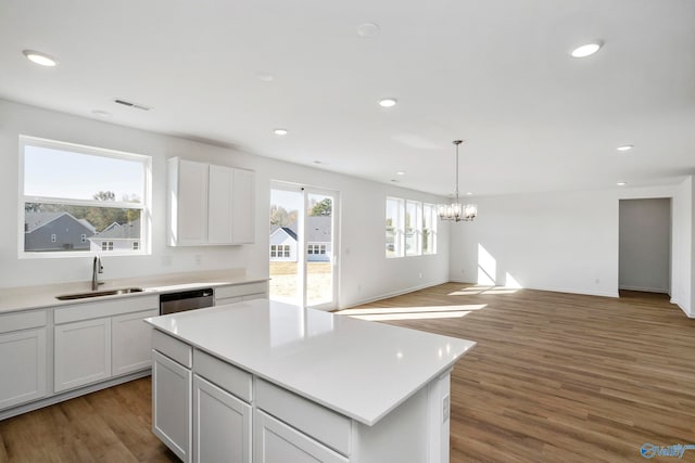 kitchen featuring dishwasher, sink, dark wood-type flooring, and white cabinets