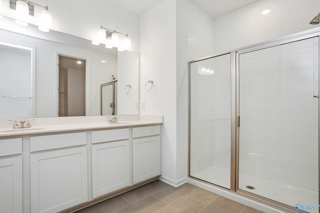 bathroom featuring tile patterned flooring, vanity, and an enclosed shower