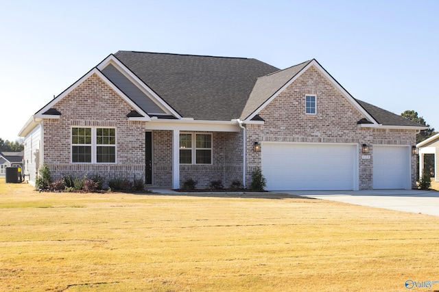 view of front facade featuring a garage, a front lawn, and central air condition unit