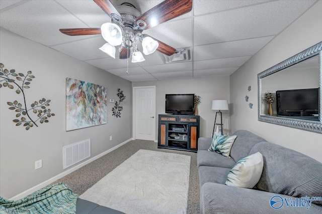 living room with ceiling fan, a paneled ceiling, and carpet